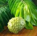 Green custard apple with leaves on a wooden surface